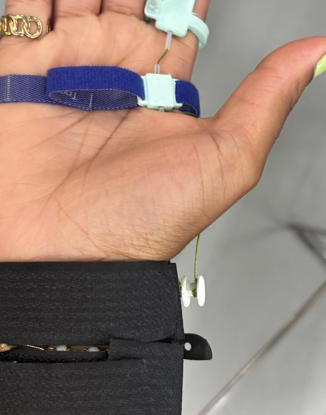 Intermediate wearable interface using a Velcro strap and removable tendon guide