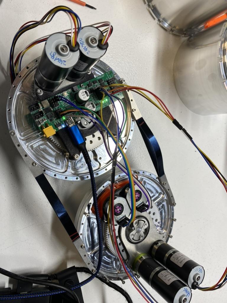 Two open underwater robot drive modules showing motors, gears, electronics, and integration wiring